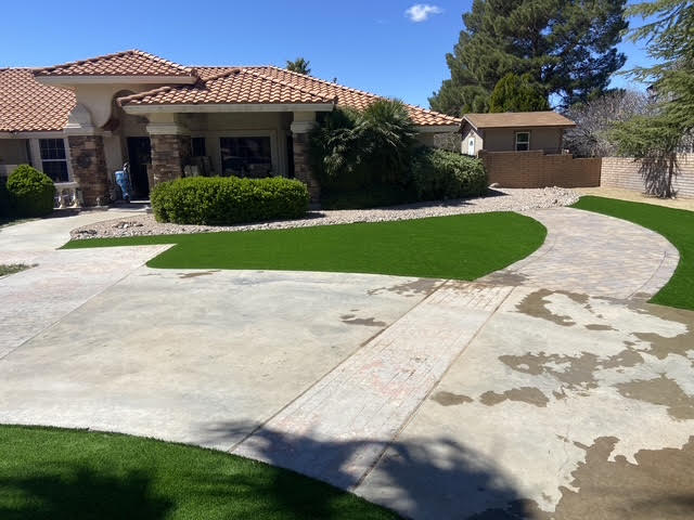 New artificial turf front lawn along a curved driveway