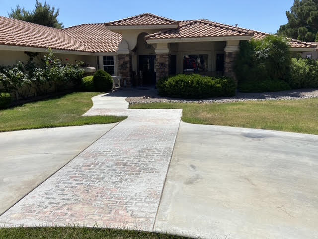 Trimmed hedges and turf in front of a tile roof home